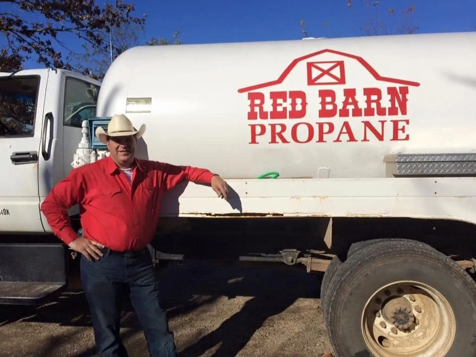 Red Barn owner standing beside the Red Barn propane truck